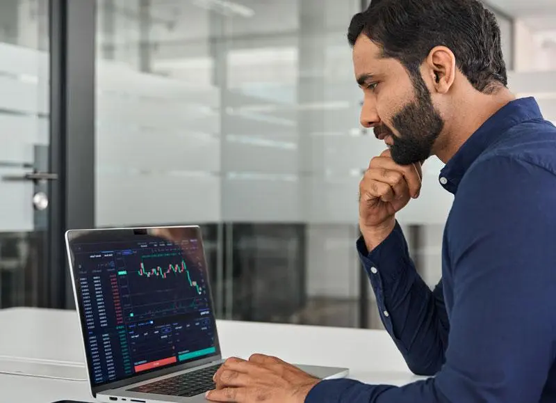 Investor analyzing stocks and a diversified investment portfolio