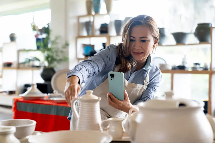 Small business owner promoting products with a smartphone